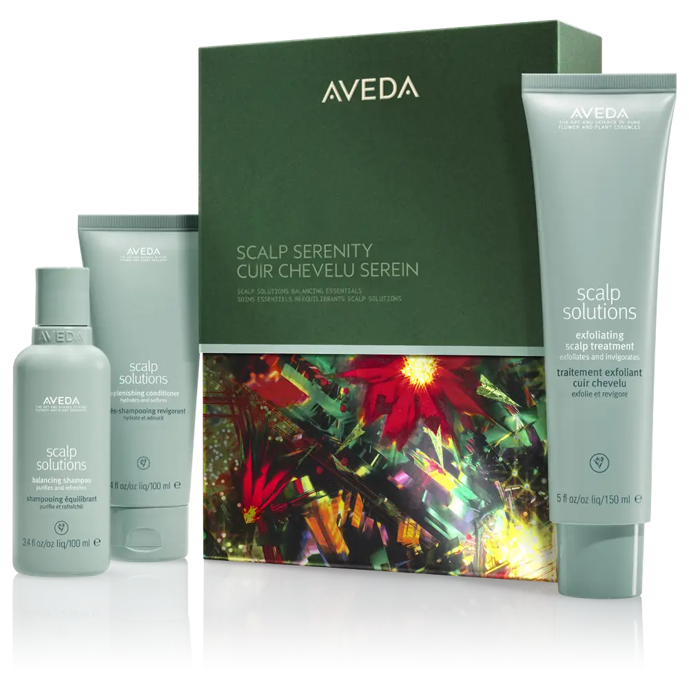 Aveda Scalp Solutions set with three products—serum, shampoo, and scalp treatment—displayed in front of a green and floral-patterned box, perfect for fall winter hair or refreshing your look with holiday hairstyle tips. - Get Panache, FL