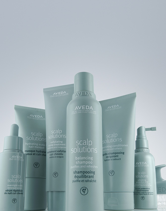 Several Aveda Scalp Solutions hair care products, including shampoo, conditioner, and treatments, are arranged upright against a light background. - Get Panache, FL