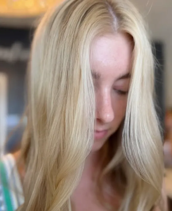 A person with long, blonde hair parted in the middle. - Get Panache, FL